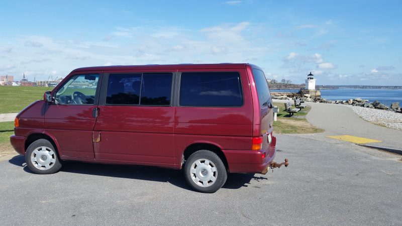 Side view of a burgundy Volkswagen Eurovan.