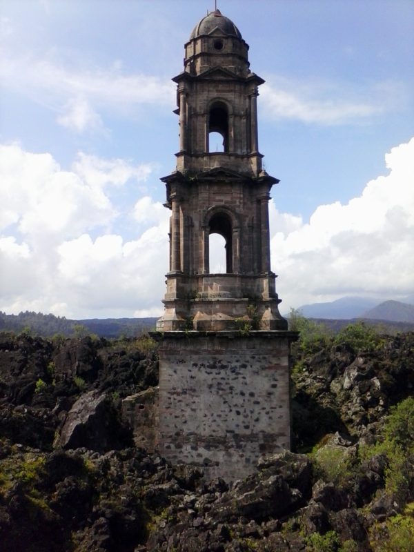A church tower buried partially buried by Volcan Paracutin poking out of the ground in the state of Michoacan, mexico., 