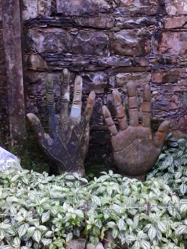 Oddly-shaped concrete installations featuring two right hands, in the jungle at Parque Edward James in Xilitla, Mexico.