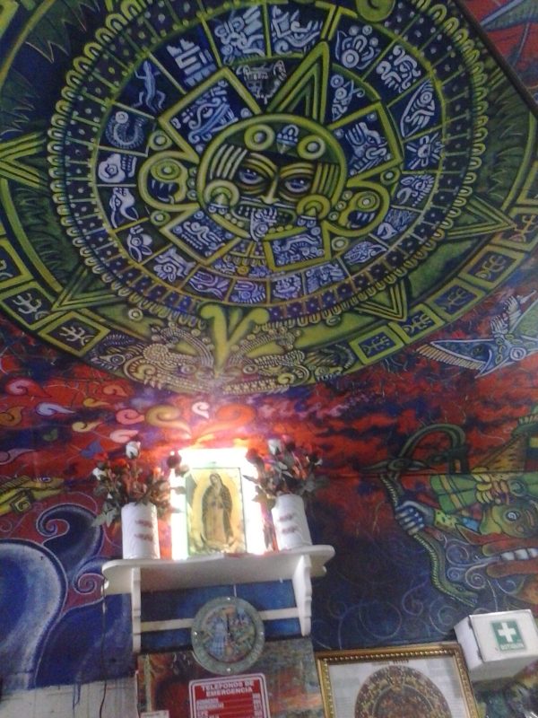 A colorful stylized Aztec symbol in a pulqueria in Mexico City.