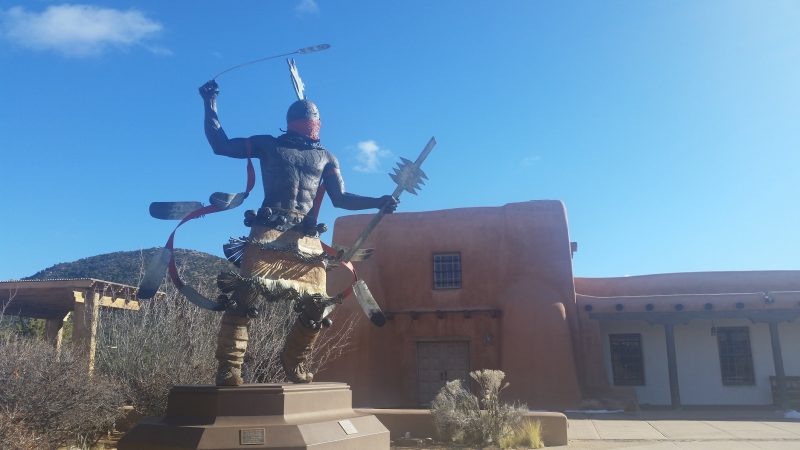 The large Apache Mountain Spirit Dancer statue in the courtyard of Museum Hill in Santa Fe.