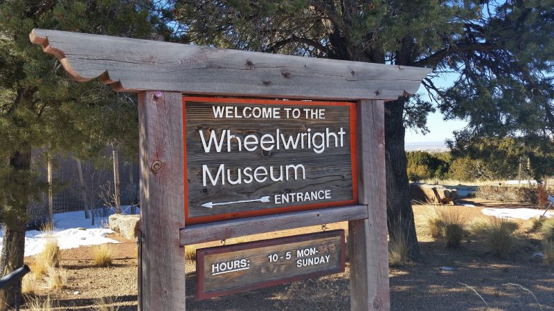 A carved wooden sign for the Wheelwright Museum in Santa Fe, New Mexico.