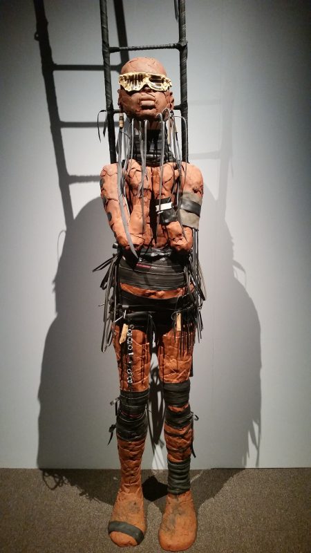 A stylized, industrial-looking terracotta figure from artist Rose B. Simpson on display at Museum hill in Santa Fe.