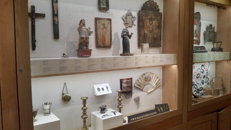 Antique religious art work in a glass display case at a museum in Santa Fe, New Mexico.