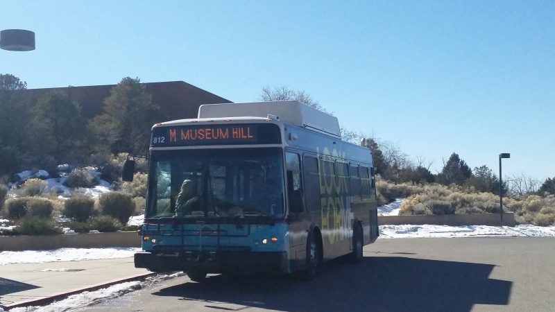 A city public transportation bus parked in front of Museum Hill in Santa Fe, New Mexico.