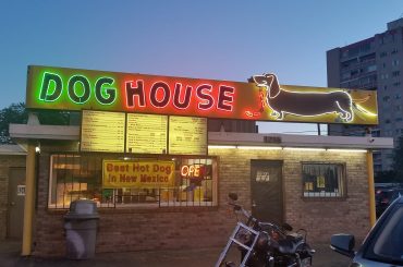 Green and red neon dachshund dog house sign in Albuquerque New Mexico.