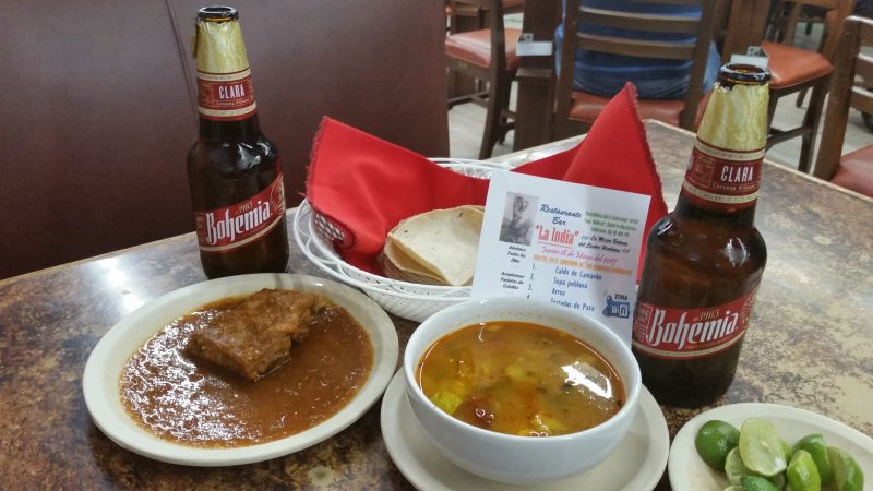 A plate of ribs and a soup, served as botanas in a cantina in Mexico City.