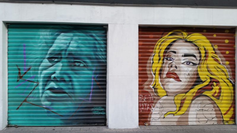 Two storefront shutters in Mexico City decorated with stylized graffiti.