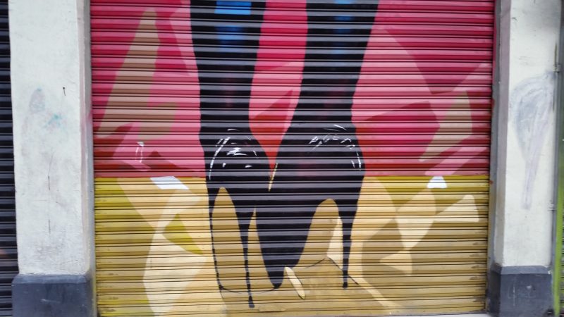 A spray painted artwork in Mexico City of a pair of high heeled shoes.
