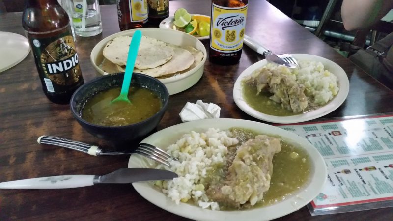 A plate of ribs and a soup, served as botanas in a cantina in Mexico City.