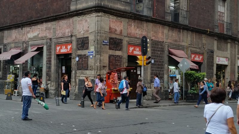 People walking in front of the La Dominica cantina in Mexico City.