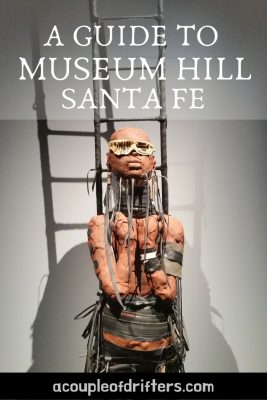 A futuristic-looking terracotta figure in font of a ladder.