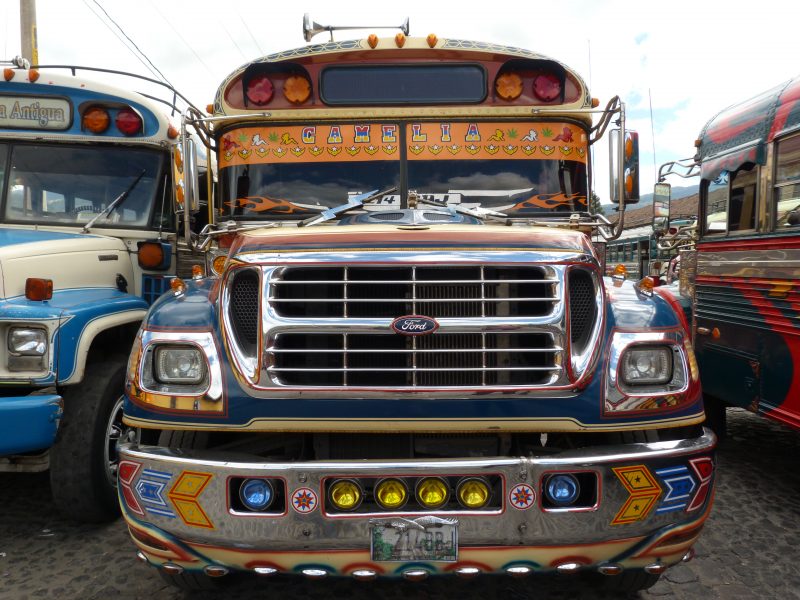 The front end of a brightly-colored chicken bu somewhere in Guatemala.