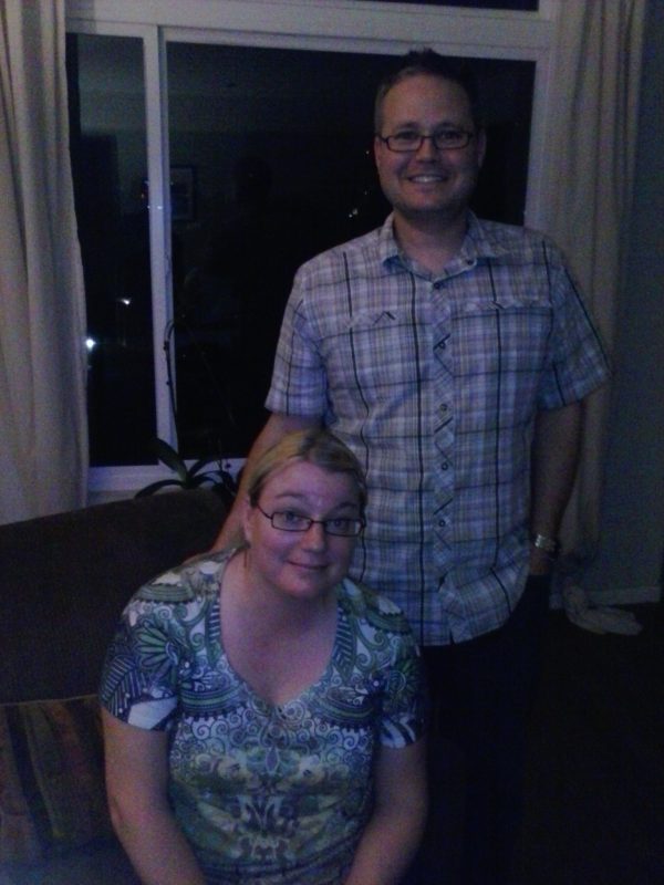 Man and woman in front of a large picture window.