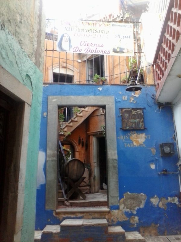 A weathered blue building of the bar Clave Azul in Guanajuato, Mexico.