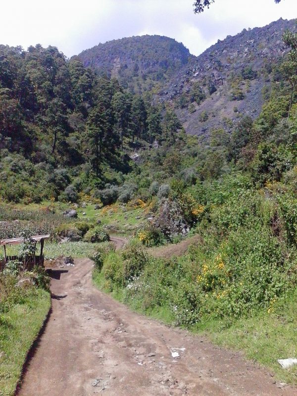 A dirt road running through lush mountains near Xela in Guatemala.