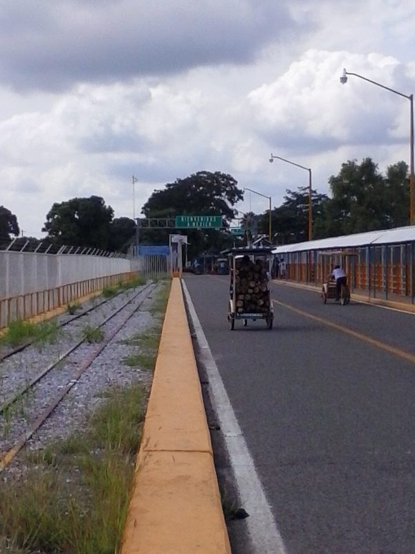 A bicycle towing a wagon while crossing the bridge from Guatemala into Mexico.