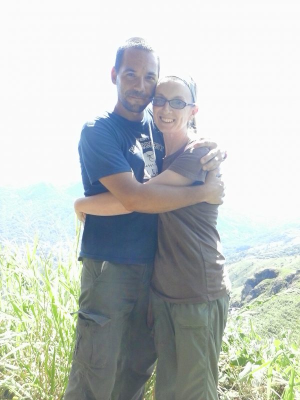 A man and a woman embracing at an overlook in San Salvador, El Salvador.