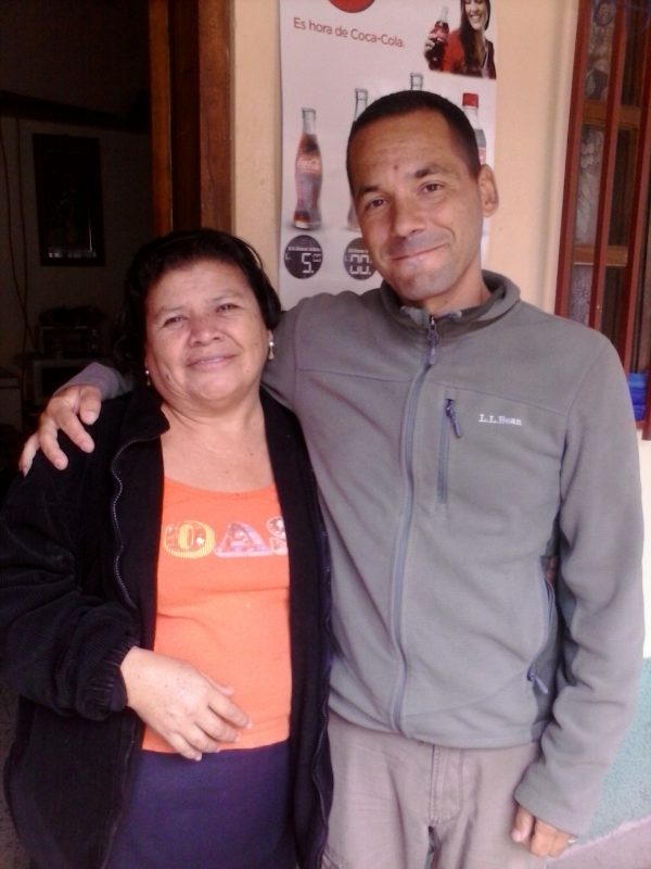 Man and woman posing in front of a shop in Honduras.