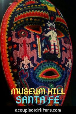 An intricate Huichol mask decorated with colorful beads.