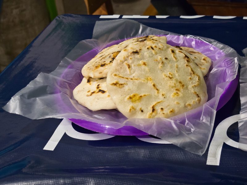 Several papusas on a purple plate.
