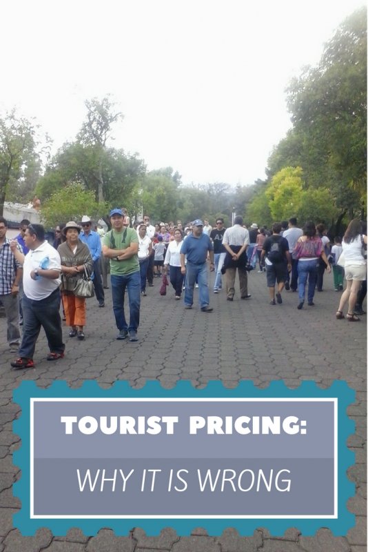 crowds of people walking in a park.