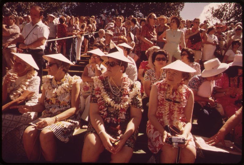 old photo of tourists wearing hats.