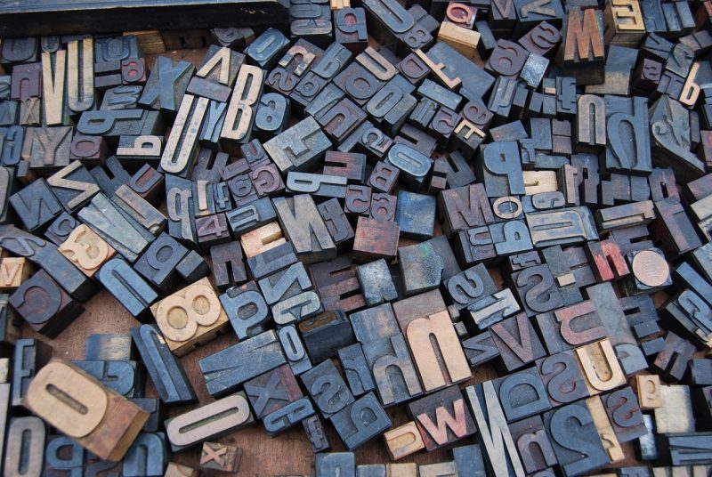 A jumble of rubber stamps featuring numbers and letters.